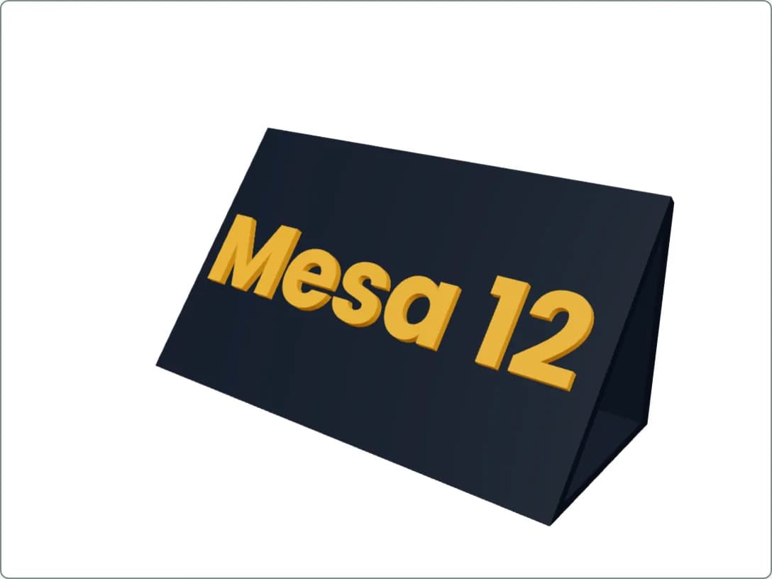 Vista 3D de un cartel de mesa gris oscuro con forma de rampa y el texto «Mesa 12» en relieve color ámbar.