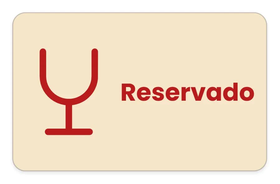 Cartel de mesa color crema de 80 × 50 mm con un icono de copa y la palabra «Reservado» en rojo.